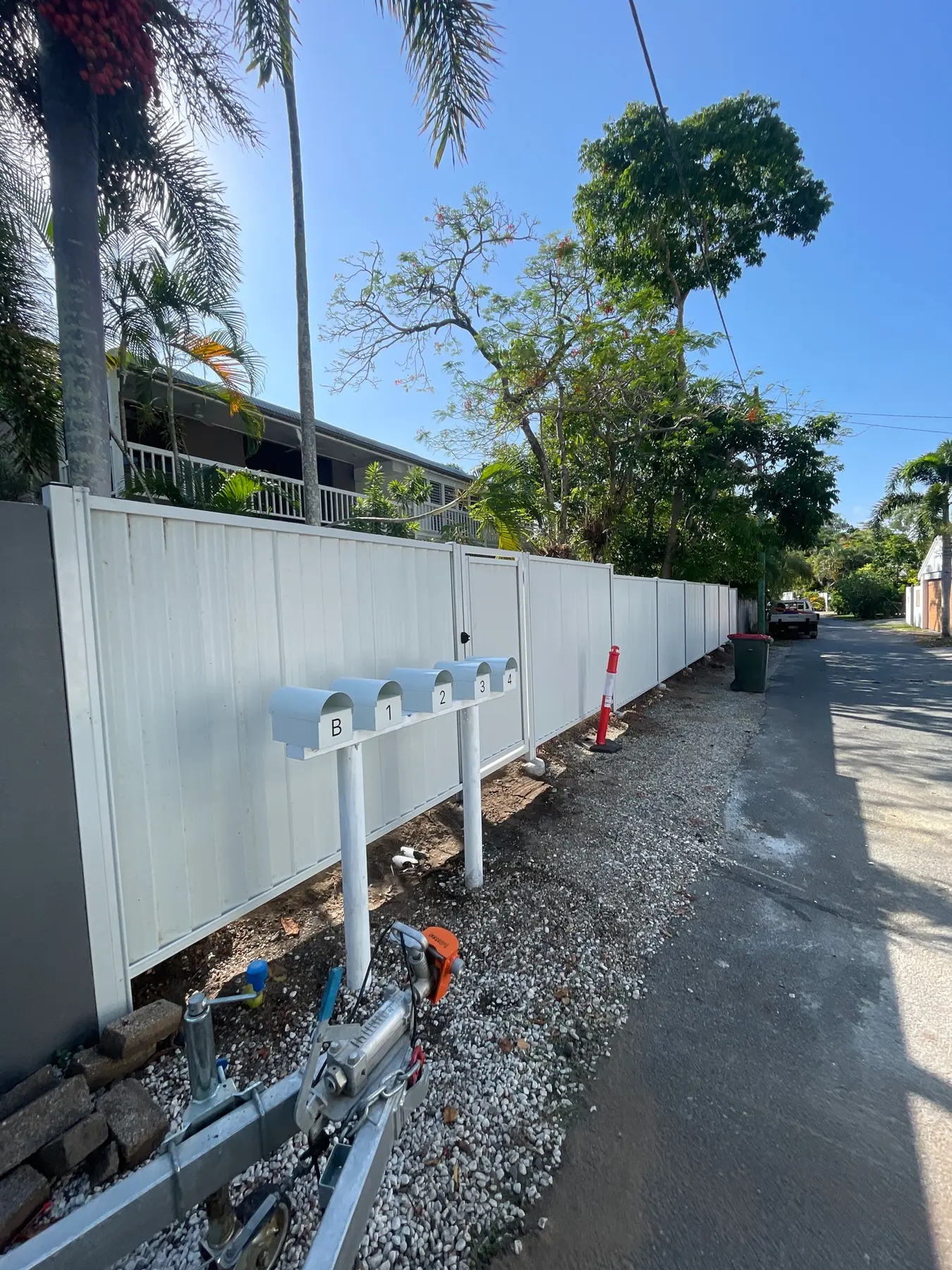 Completed white Colorbond boundary fence and access gate
