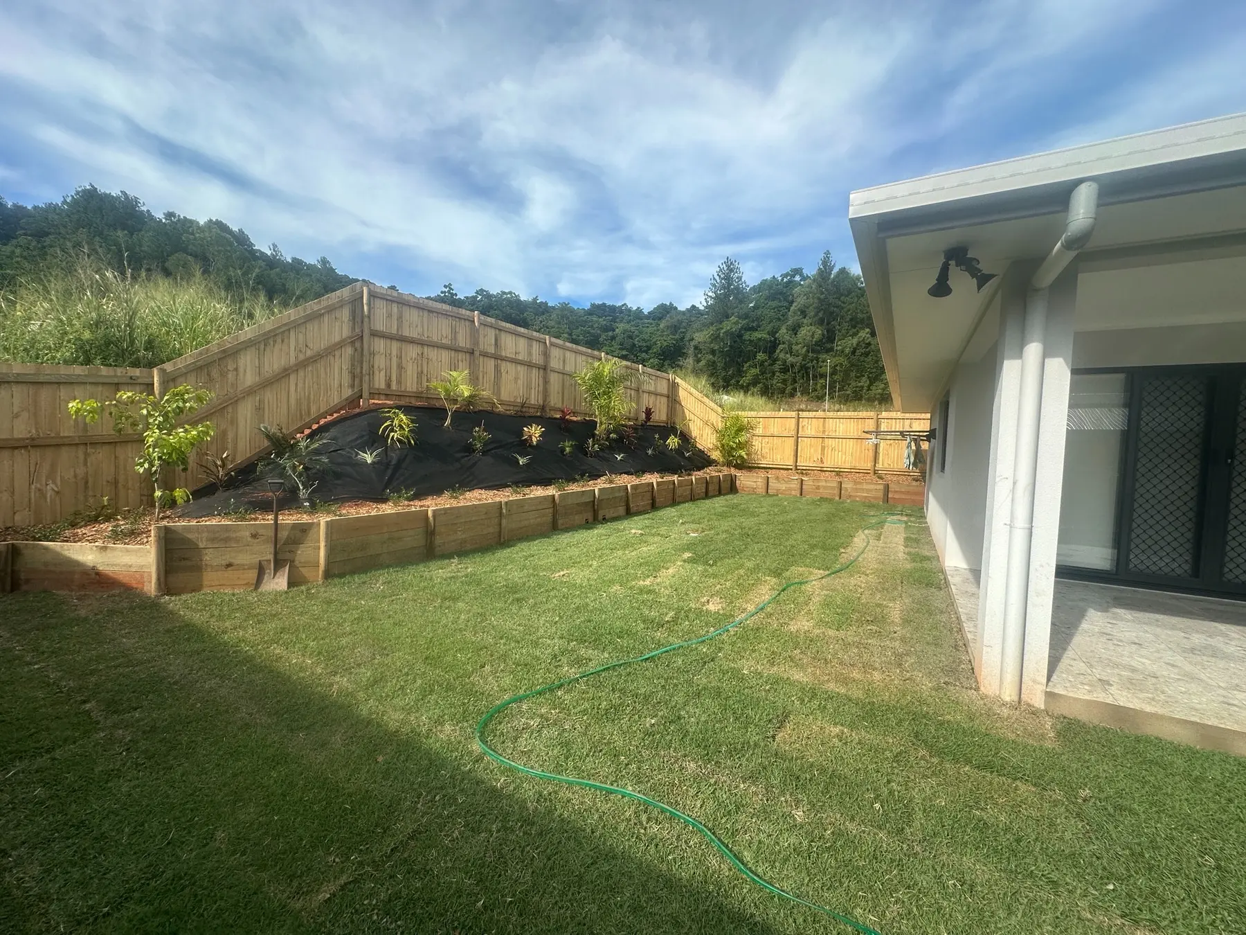 Completed timber retaining walls, tropical garden and lawn