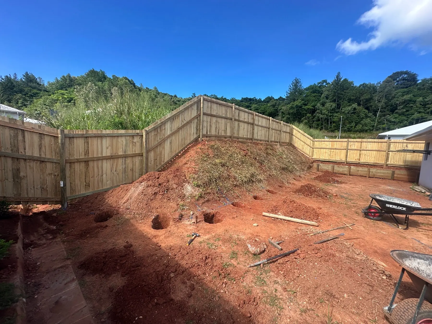 Timber boundary fence and retaining project at an early construction stage