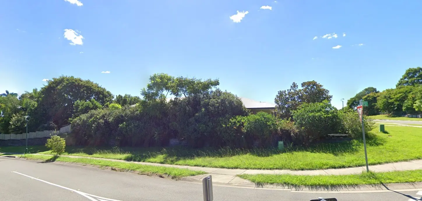 Overgrown corner property and verge before a large garden clean-up