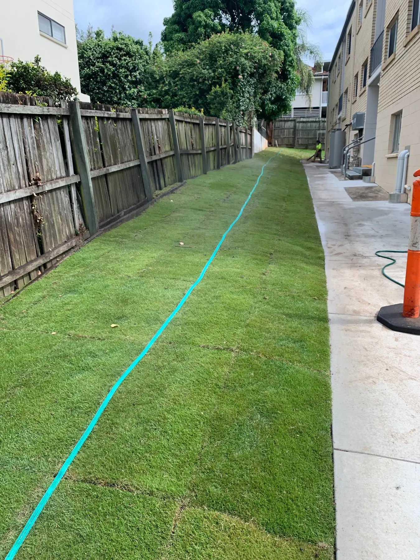 Relevelled apartment side yard after installation of fresh turf